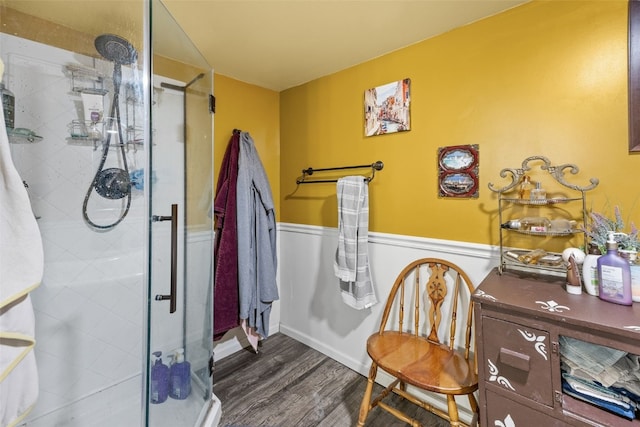 230 E Market St, Lisbon, IA 52253 - full bath featuring a stall shower, a wainscoted wall, and wood finished floors