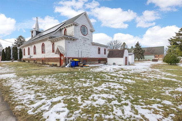 230 E Market St, Lisbon, IA 52253 - snow covered property with an outbuilding and a storage unit