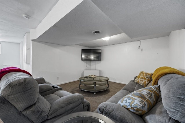 living area with baseboards, visible vents, dark carpet, and a textured ceiling