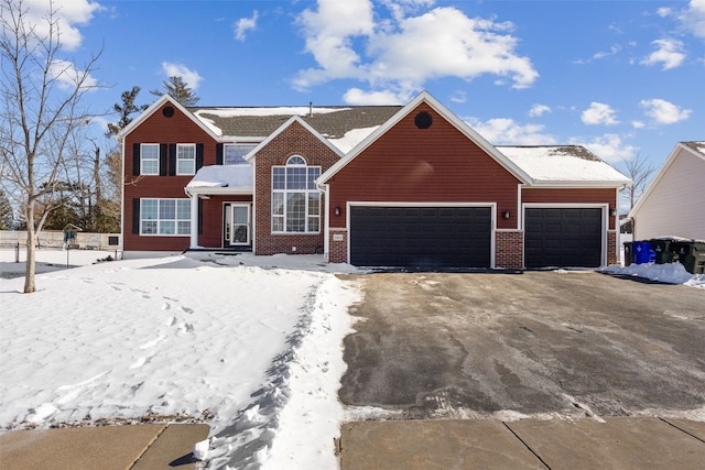 traditional home featuring an attached garage and brick siding