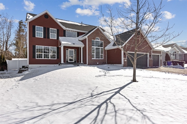 traditional-style home with a garage and brick siding