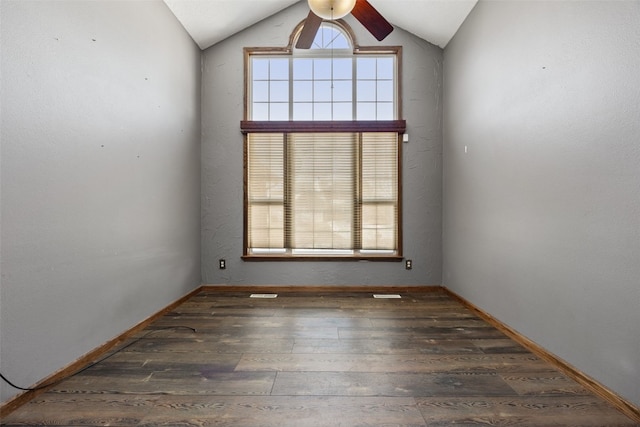 unfurnished room with dark wood-style floors, lofted ceiling, ceiling fan, and baseboards