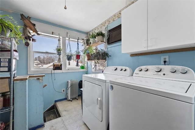 laundry room with light floors, separate washer and dryer, cabinet space, and radiator