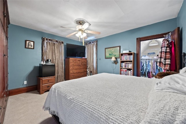 bedroom featuring a ceiling fan, light carpet, and baseboards