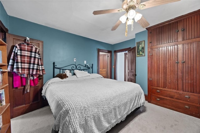 bedroom featuring light carpet and a ceiling fan