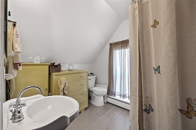 full bath featuring lofted ceiling, toilet, and baseboard heating