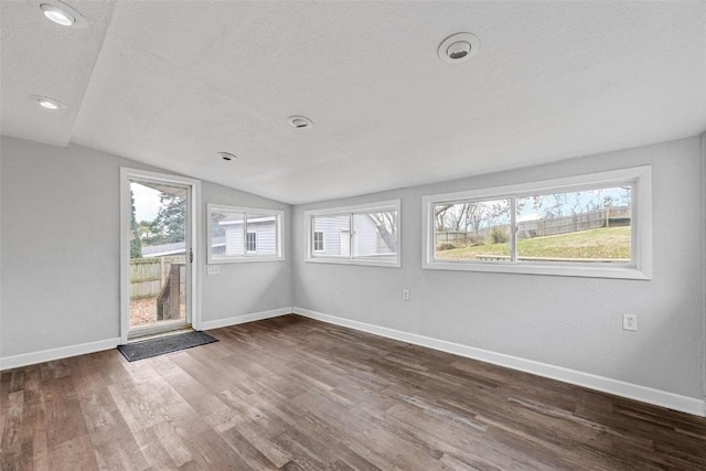 unfurnished sunroom featuring lofted ceiling and a healthy amount of sunlight