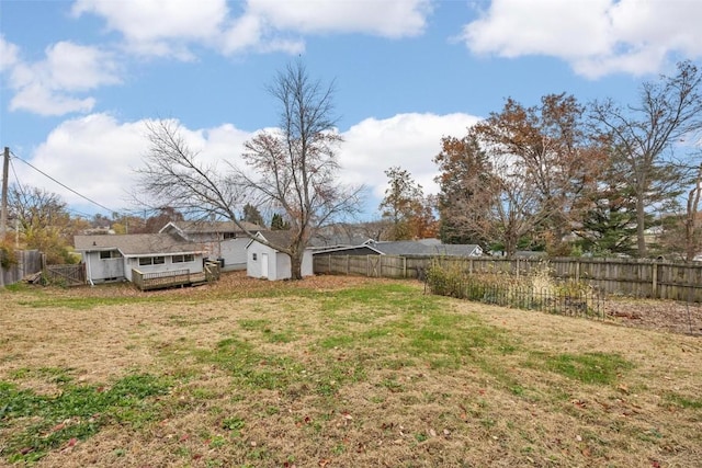 view of yard featuring an outbuilding, a storage unit, and a fenced backyard