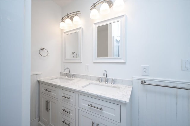 full bathroom featuring double vanity and a sink