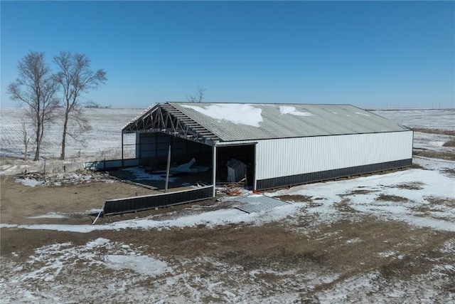 snow covered structure featuring an outbuilding and an outdoor structure