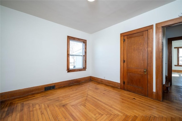 empty room featuring visible vents and baseboards