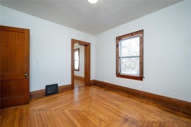 empty room with baseboards and visible vents