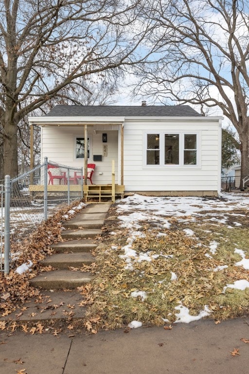 view of front of home with fence and a porch