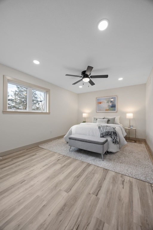 bedroom with recessed lighting, ceiling fan, light wood-style flooring, and baseboards