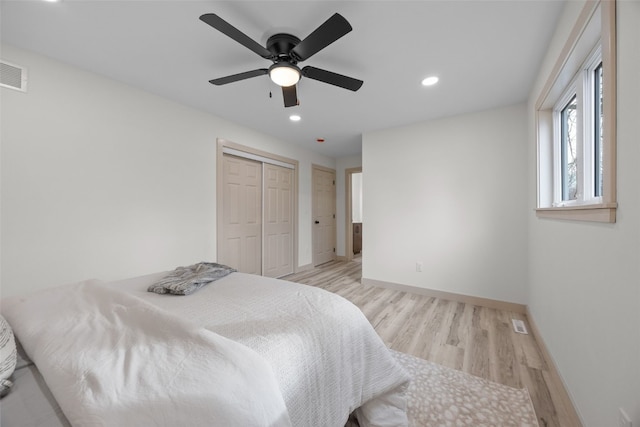 bedroom with recessed lighting, a ceiling fan, baseboards, a closet, and light wood-type flooring