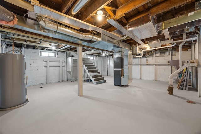 basement with heating unit, stairs, and water heater