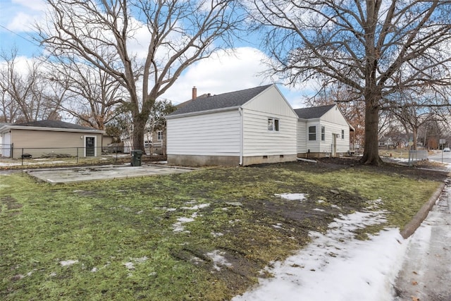 exterior space with crawl space, a yard, a chimney, and fence