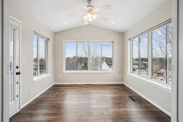 unfurnished sunroom featuring lofted ceiling, ceiling fan, visible vents, and a wealth of natural light