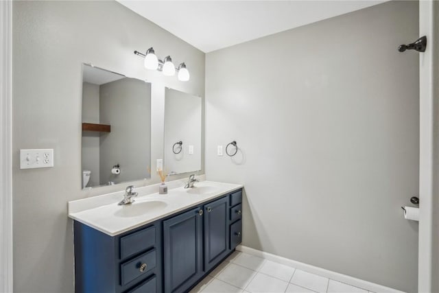 full bathroom featuring tile patterned floors, a sink, toilet, and double vanity