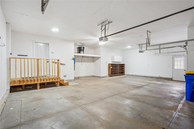 garage with a garage door opener and baseboards