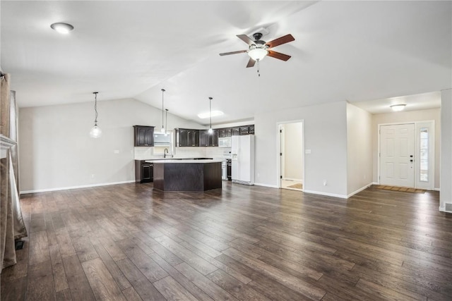 unfurnished living room with dark wood-style floors, a fireplace, vaulted ceiling, ceiling fan, and baseboards