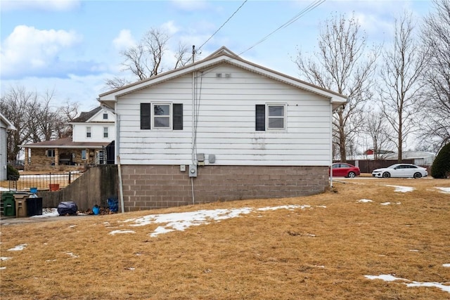 view of side of property with a lawn