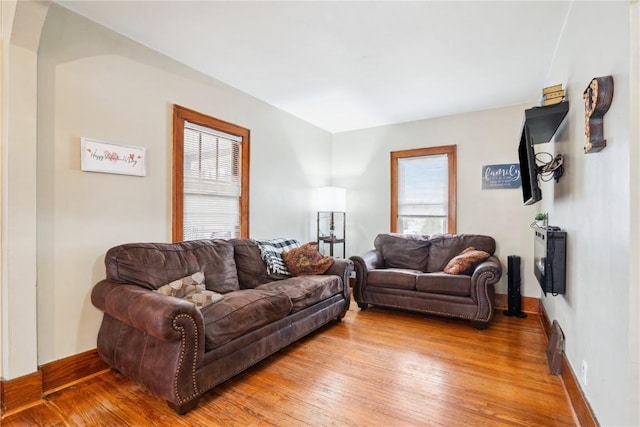 living room with baseboards and wood finished floors