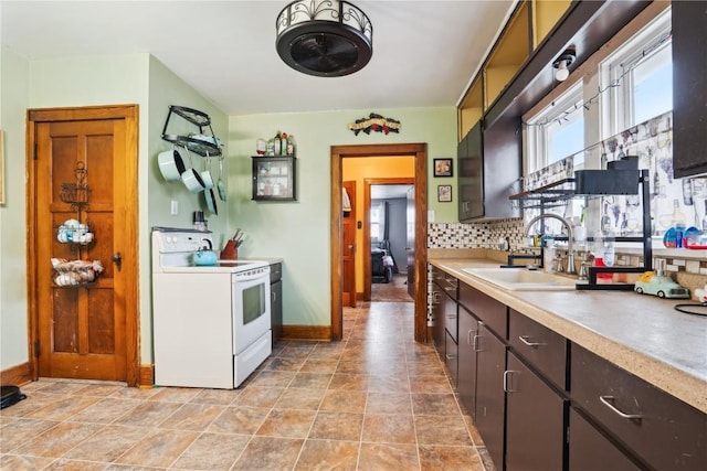 kitchen featuring dark brown cabinetry, white electric range, a sink, light countertops, and tasteful backsplash