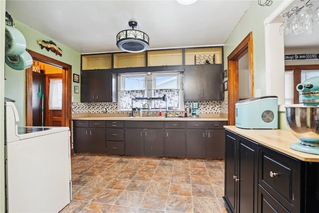 kitchen featuring light countertops, freestanding refrigerator, white range with electric stovetop, and tasteful backsplash