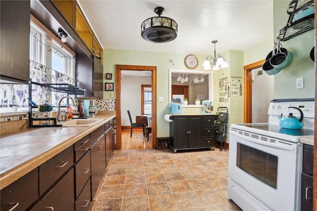 kitchen with dark brown cabinetry, white electric range oven, light countertops, and a sink