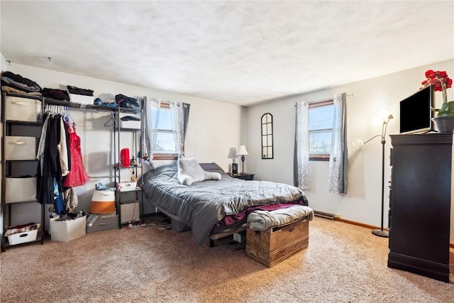 bedroom featuring baseboards, multiple windows, and light colored carpet