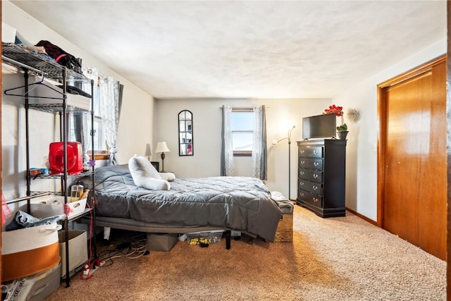 carpeted bedroom with baseboards