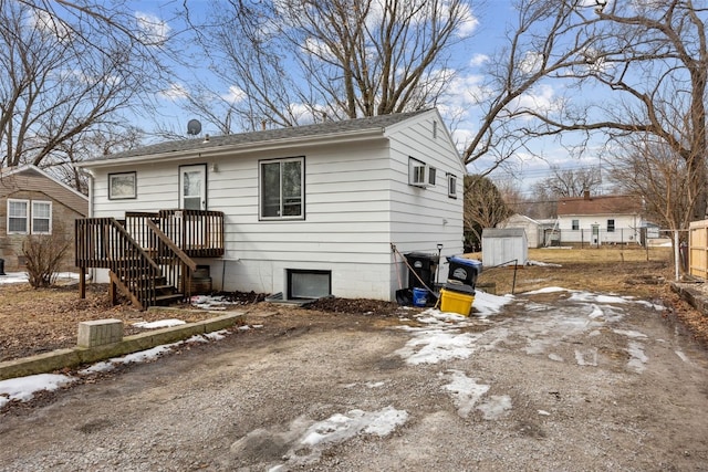 view of front of property with dirt driveway and fence