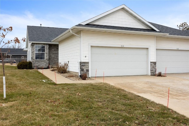 view of front of property featuring driveway, a shingled roof, stone siding, an attached garage, and a front lawn