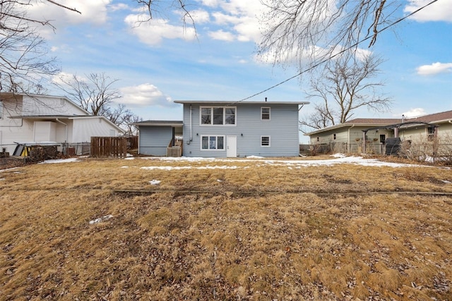 back of house with fence