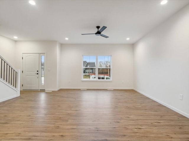 interior space featuring stairs, light wood-type flooring, and recessed lighting