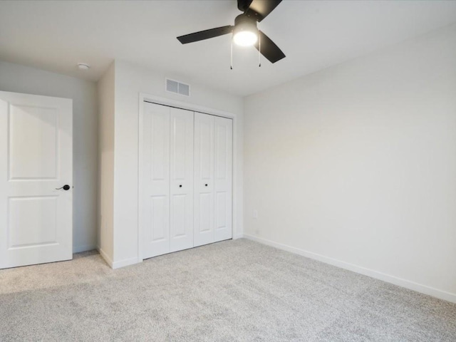 unfurnished bedroom featuring light carpet, visible vents, and baseboards