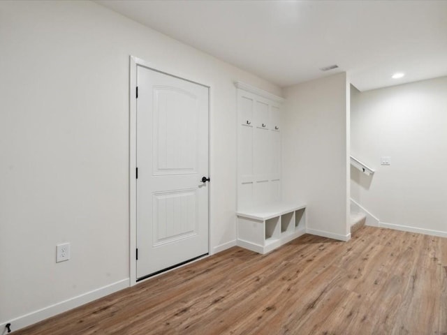 mudroom featuring light wood-type flooring, baseboards, and recessed lighting