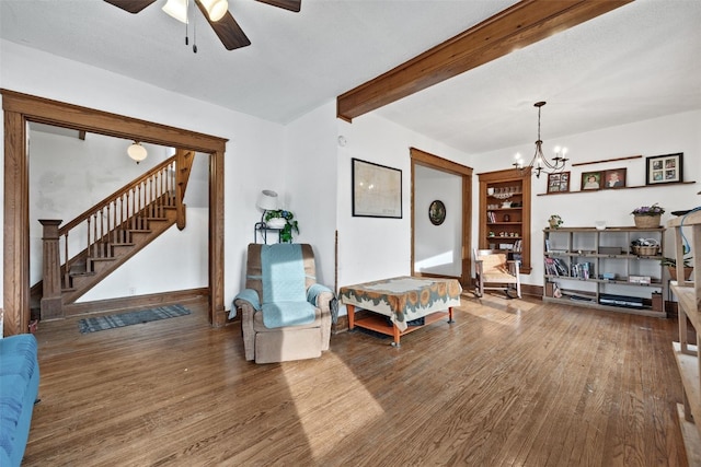 interior space with baseboards, stairway, wood finished floors, beam ceiling, and ceiling fan with notable chandelier