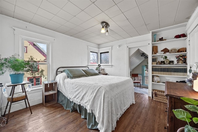 bedroom with dark wood finished floors