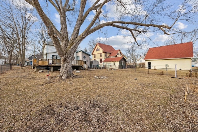 view of yard featuring a fenced backyard, a residential view, and a wooden deck