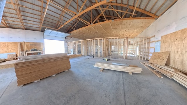 misc room featuring high vaulted ceiling and concrete floors