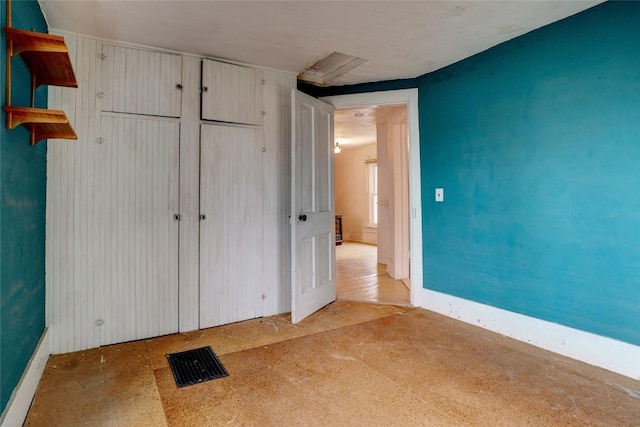 unfurnished bedroom featuring a closet and visible vents