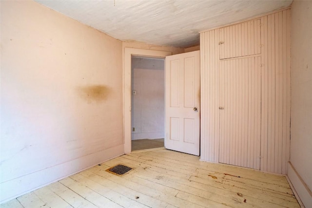 unfurnished room with light wood-style floors