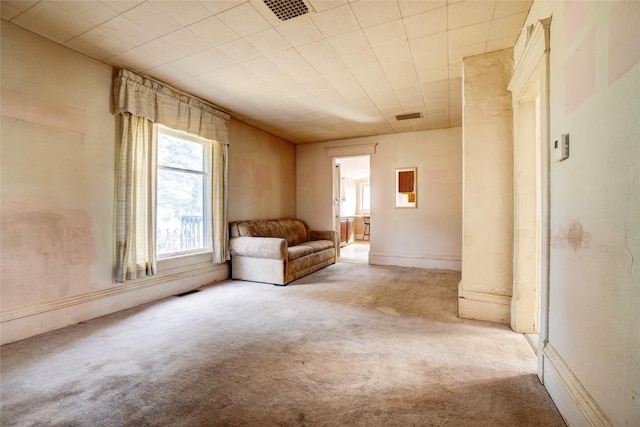 unfurnished room featuring carpet and visible vents