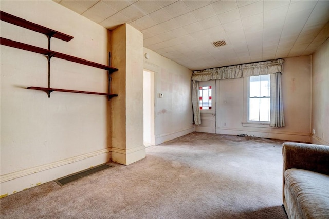 interior space with carpet floors and visible vents