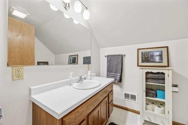 bathroom with lofted ceiling, tile patterned flooring, visible vents, and vanity