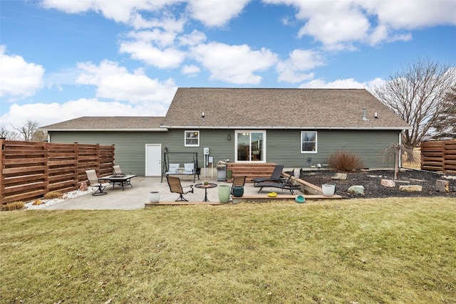 back of house featuring a fire pit, a patio, and a lawn