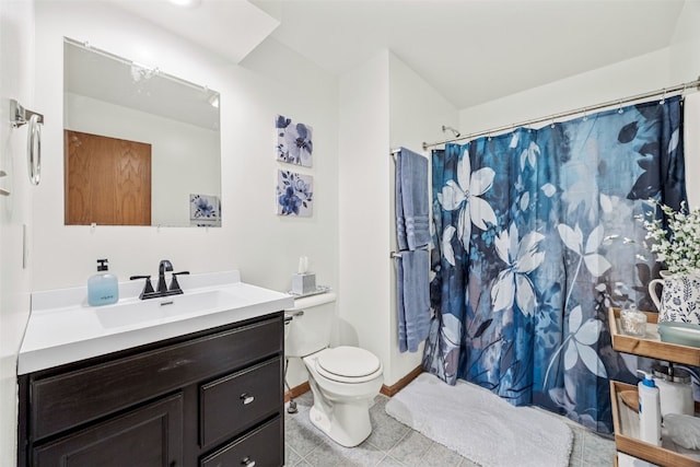 bathroom with a shower with shower curtain, vanity, toilet, and baseboards