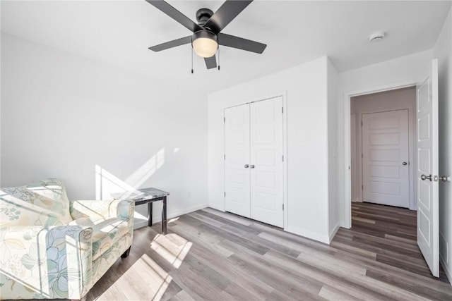 unfurnished room featuring ceiling fan, baseboards, and wood finished floors